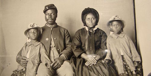 Unidentified_african_american_soldier_in_union_uniform_with_wife_and_two_daughters-